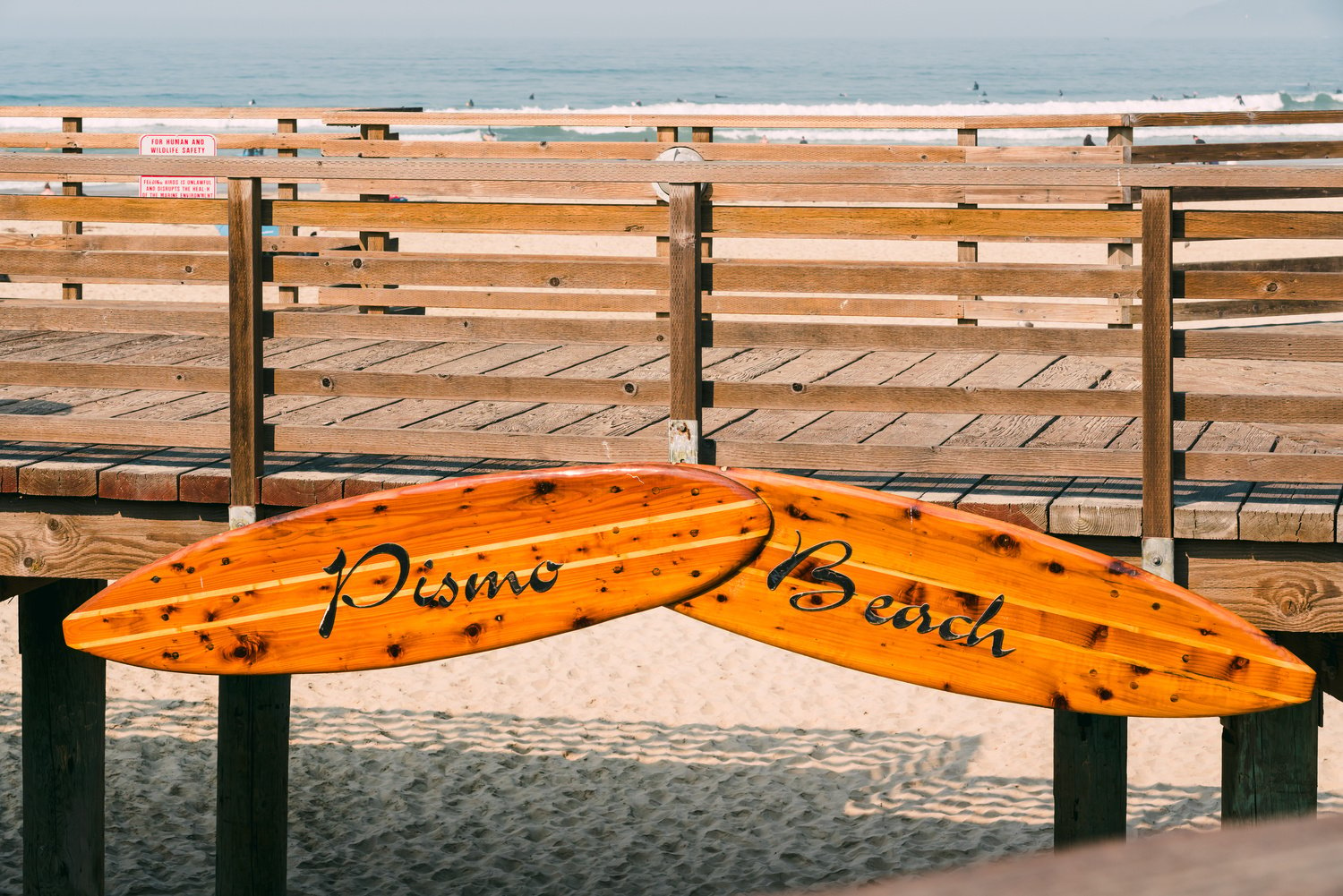 Pismo Beach sign on wooden boardwalk. Pismo Beach pier, Central California coast